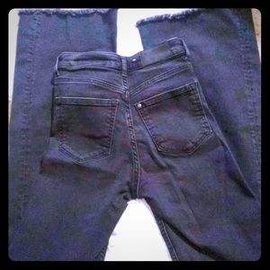 Black flare jeans with frayed hem
